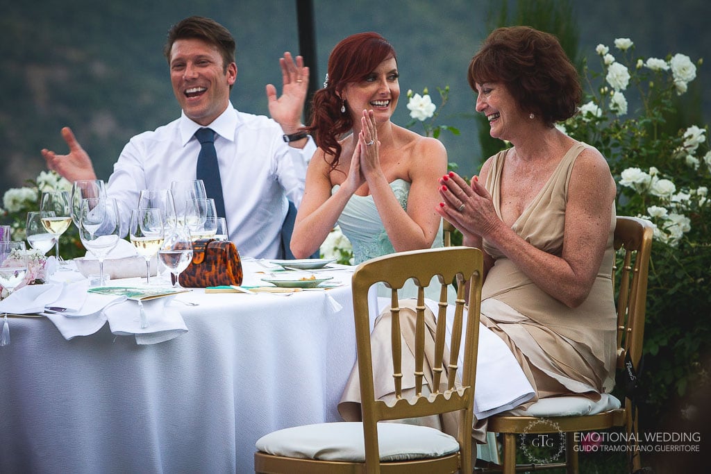 wedding couple and mother of the bride clapping for father's speech at an italian wedding in ravello
