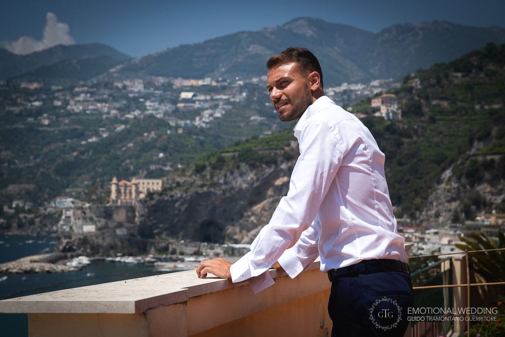 groom enjoying the view from his balcony before getting ready for his wedding in maiori