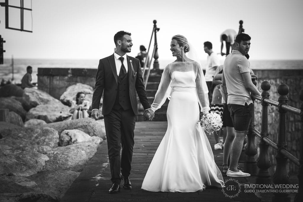 bride and groom walking on the pier in Amalfi