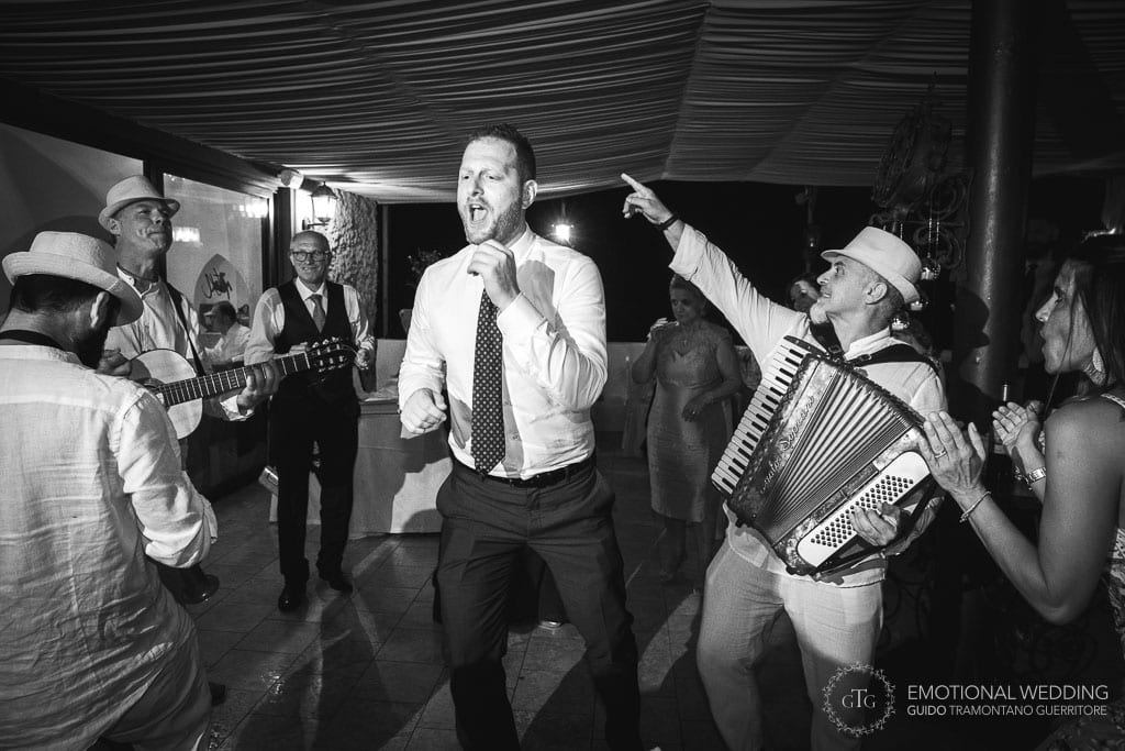 guest dancing on the beat of musicians at a wedding party in maiori