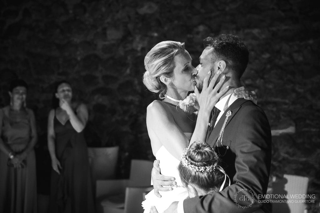 bride kissing the groom at their first dance at Torre Normanna in maiori