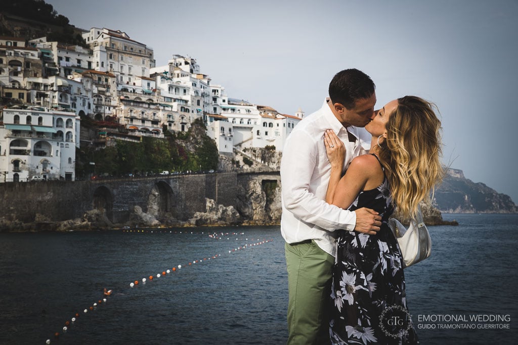 couple kissing on the pier after a marriage proposal in amalfi