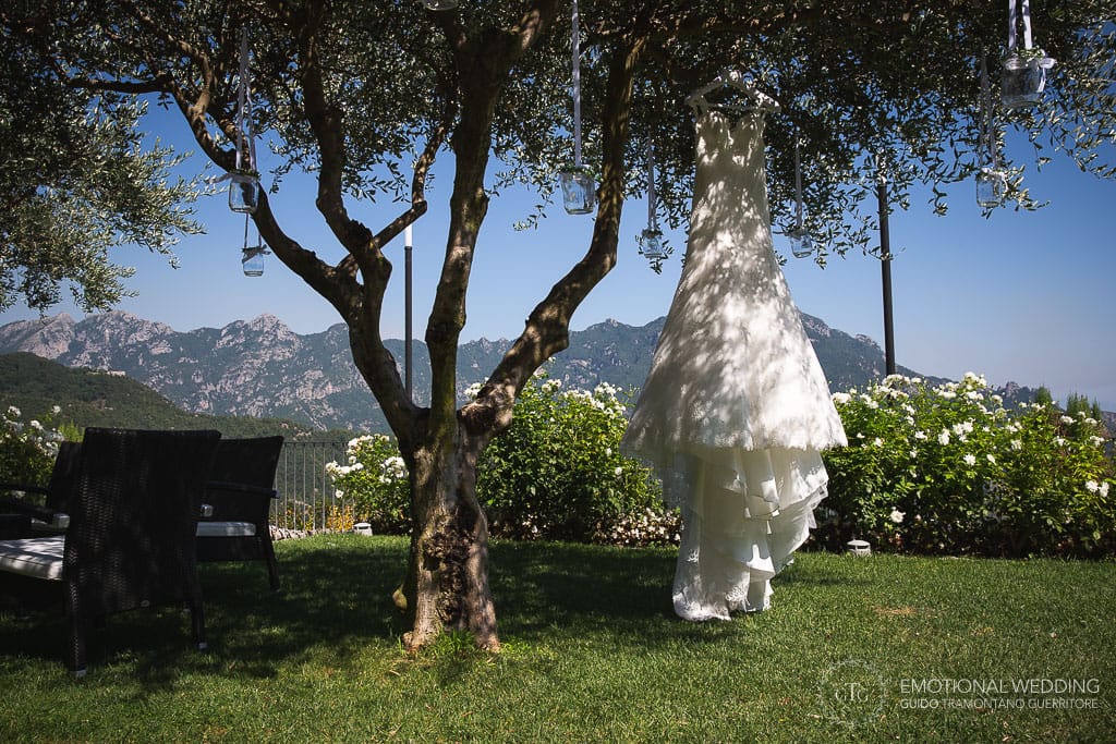 wedding dress hung on a tree in the garden at hotel caruso in ravello