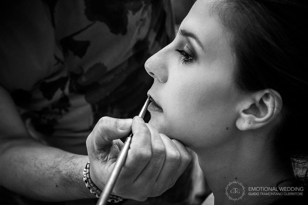 bride portrait and her make up artist is at work