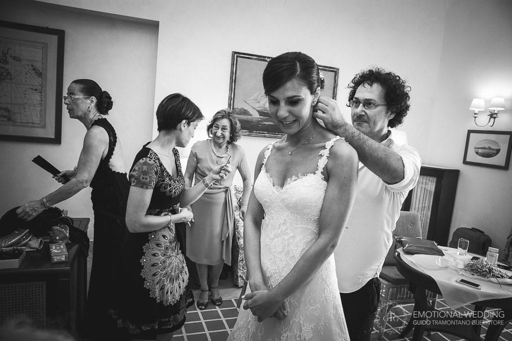 hairstylist makes last adjustments to the bride