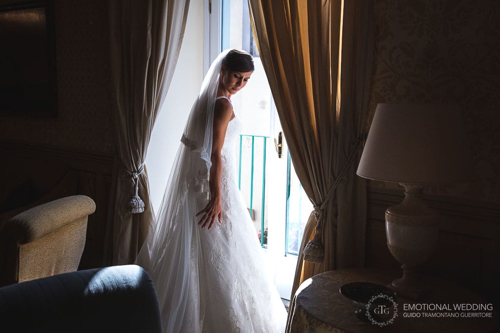 the bride looking out the window at hotel Belmont Caruso in ravello