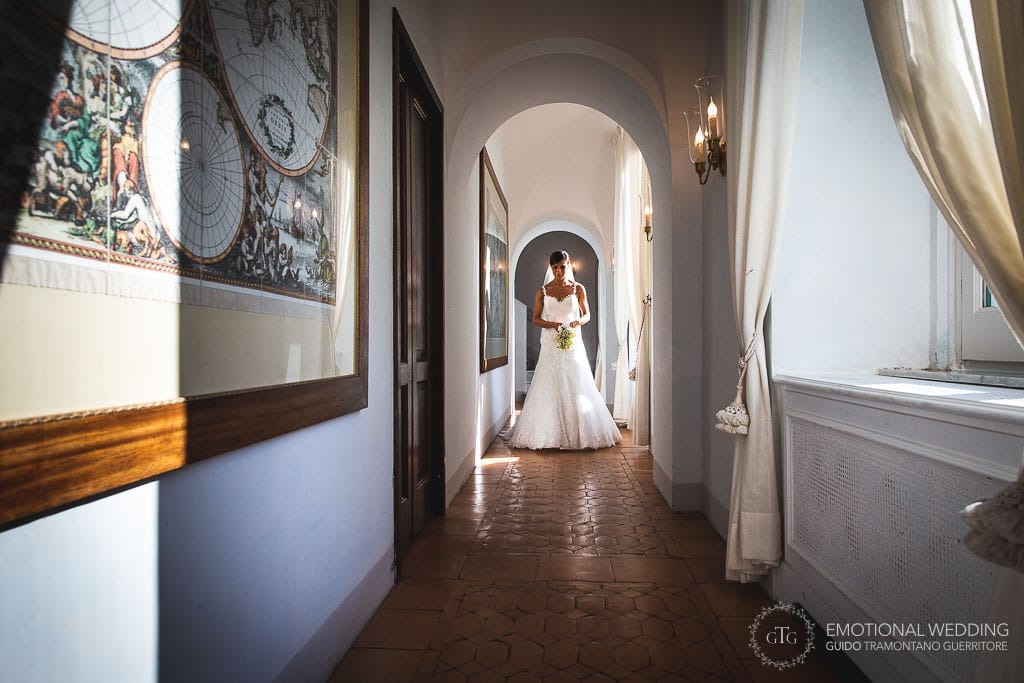 a bride walking down the corridors at hotel caruso in ravello
