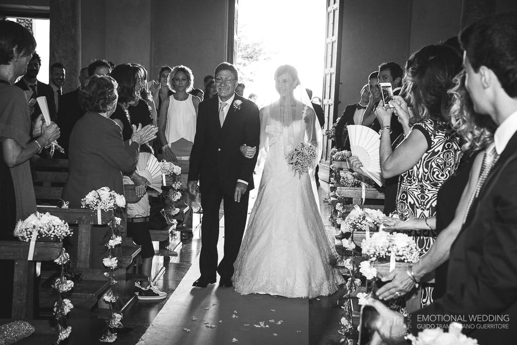 the bride and her father walking down the aisle