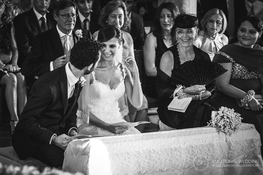 wedding couple and guests laugh during the ceremony