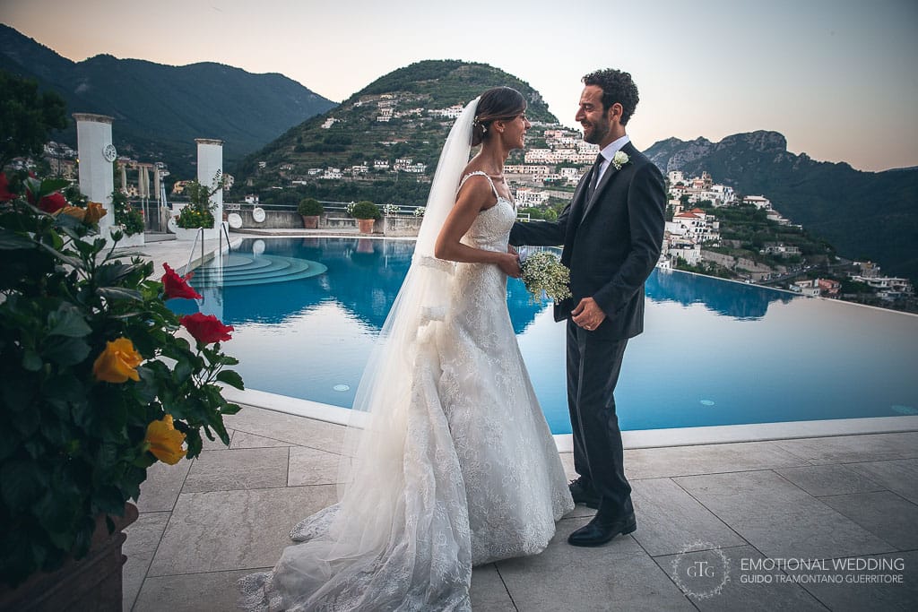 bride and groom by the infinity pool at hotel caruso in ravello