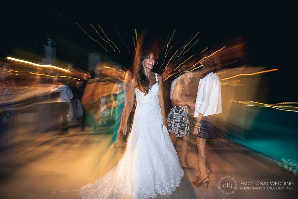bride smiles while dancing at her wedding party at hotel Caruso in ravello