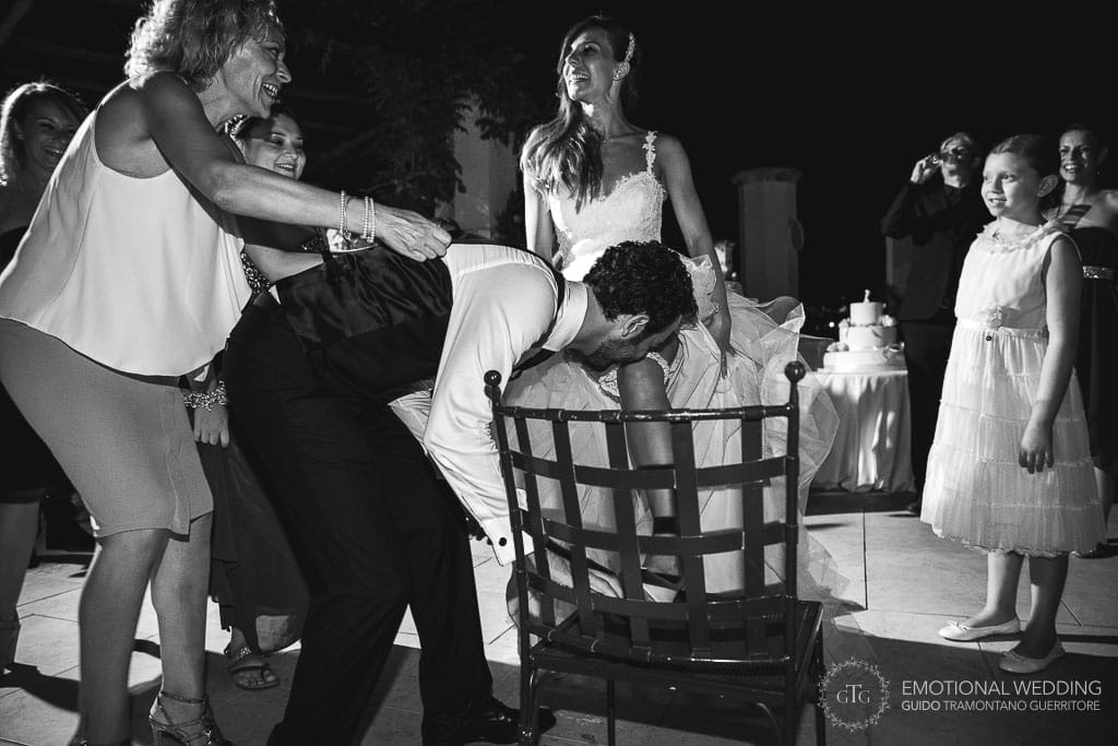 groom takes off the bride's garter with his teeth