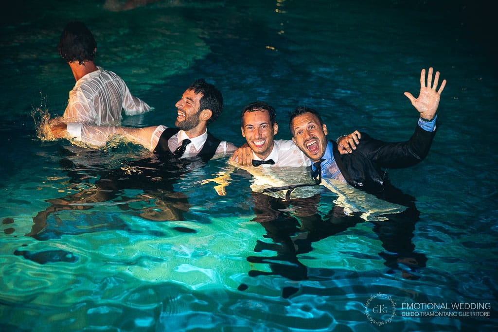 the groom and his friends having fun during wedding party in the swimming pool at hotel Caruso in ravello