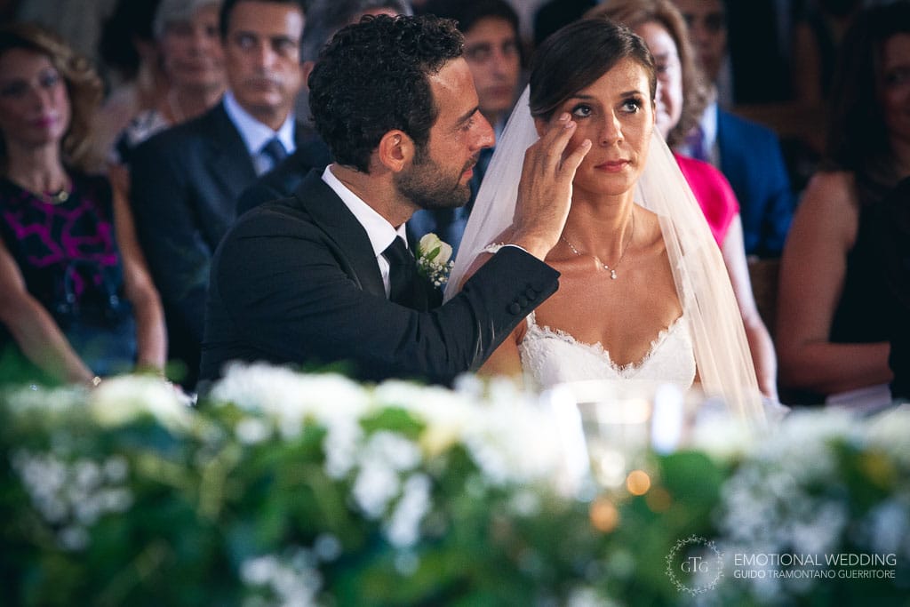 groom wipes away bride's tears at a wedding in ravello