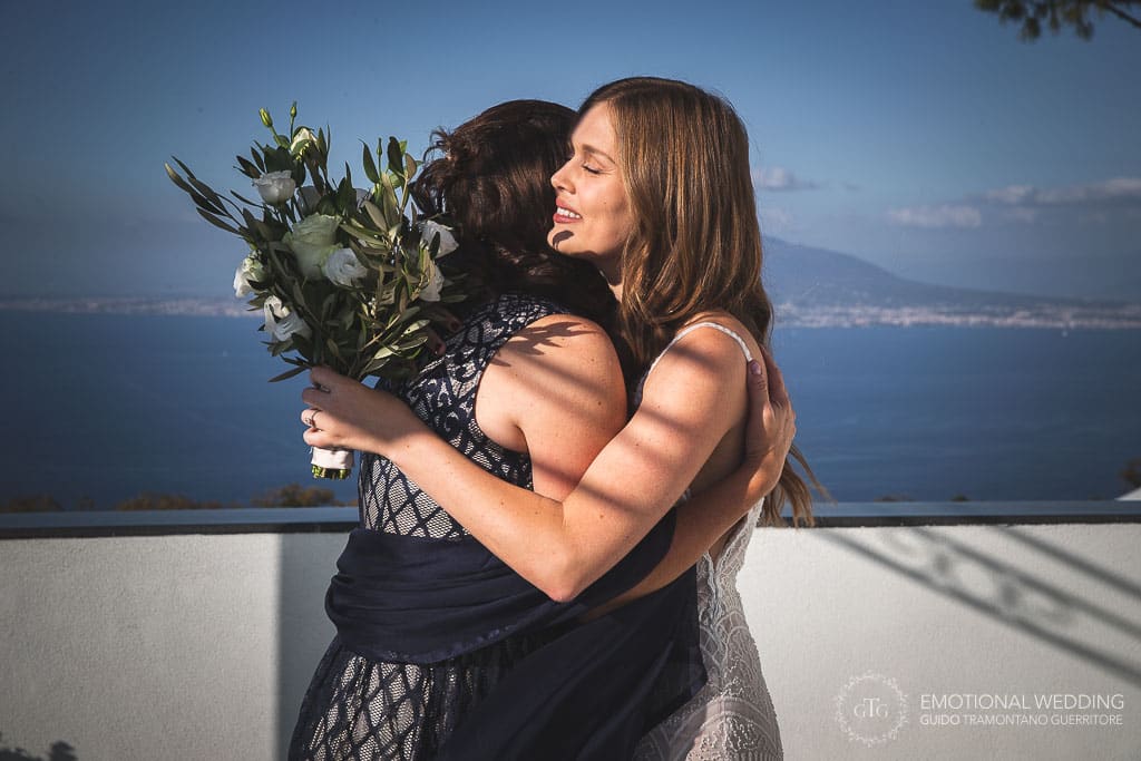 bride and mother hugging before wedding ceremony in sorrento