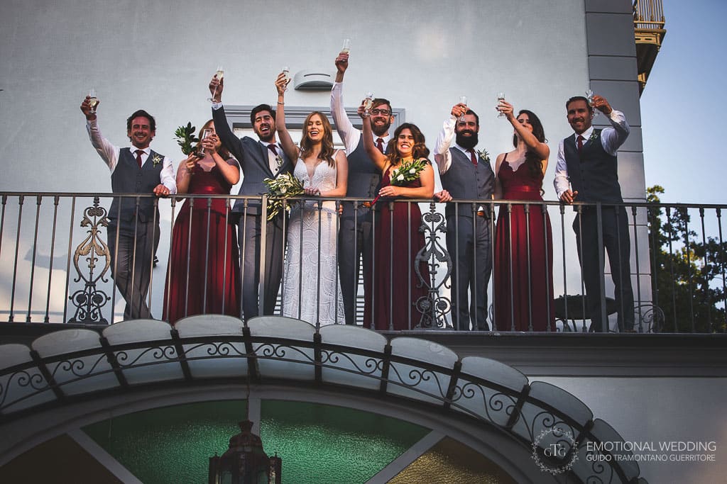 wedding couple and bridal party toast at villa oasi olimpia in Sorrento