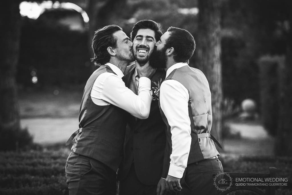 best men kissing the groom at wedding in Sorrento