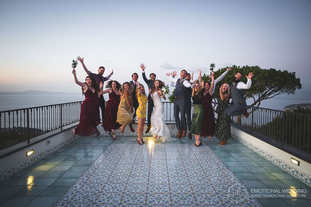 wedding couple and guests jumping on the terrace of villa oasi olimpia in Sorrento