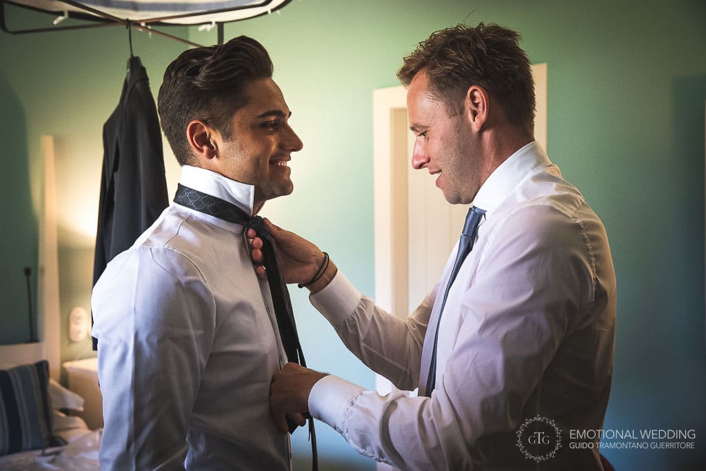 groom and friend getting ready for wedding ceremony in tuscany