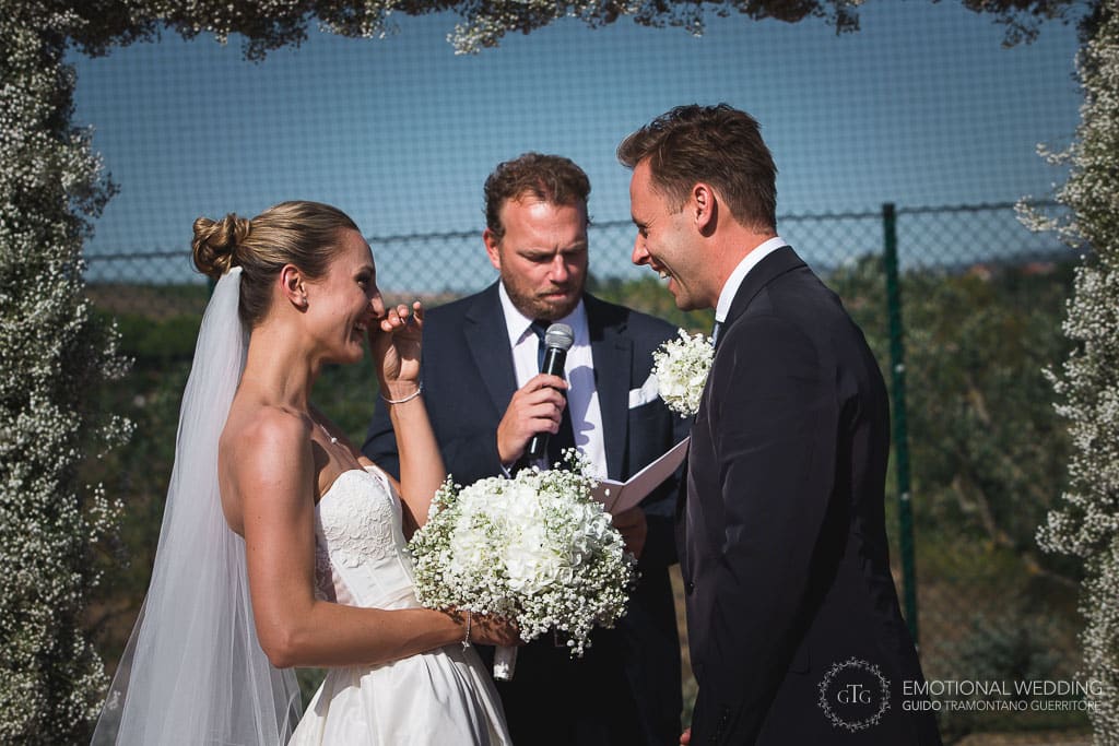 bride and groom laughing during wedding ceremony in tuscany