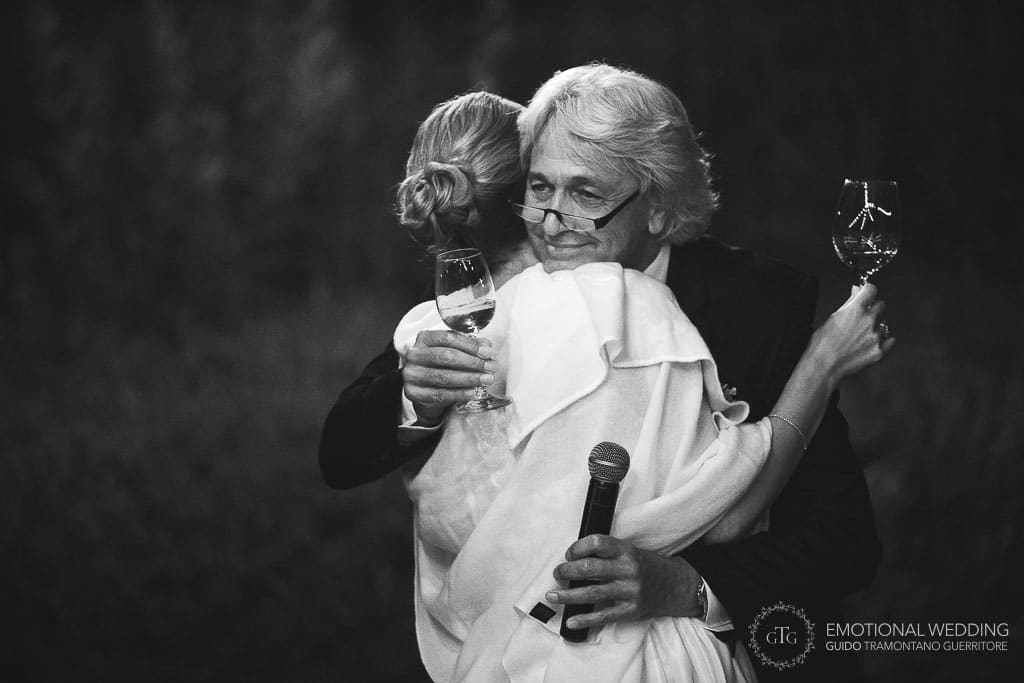 bride and gather hugging at wedding reception at Locanda Rossa in tuscany