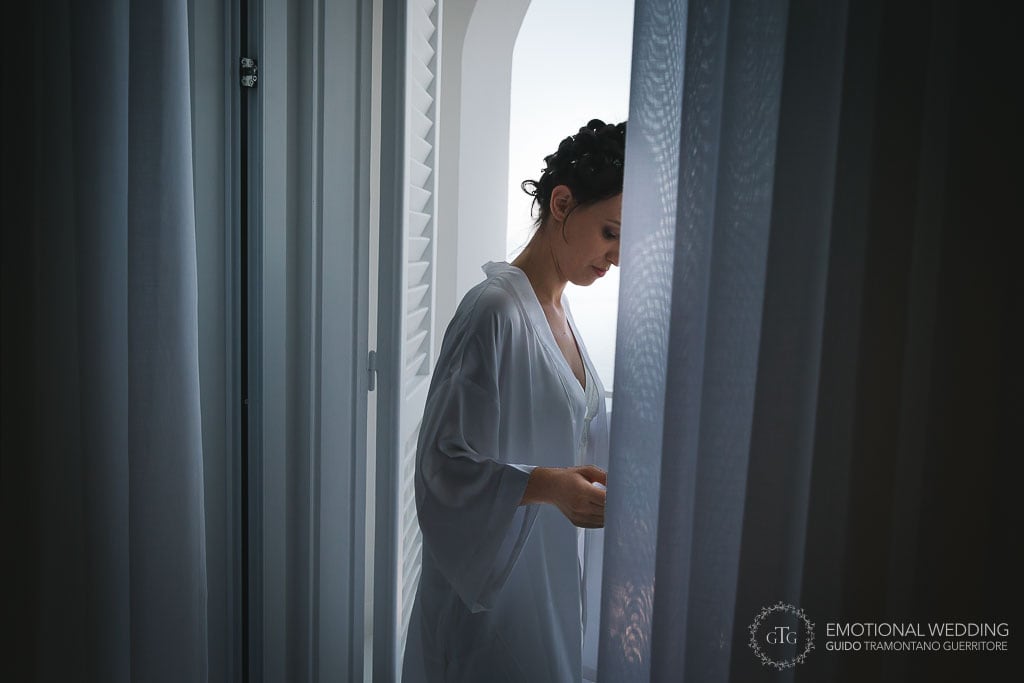 candid portrait of a bride in her hotel room while getting ready for her wedding in praiano