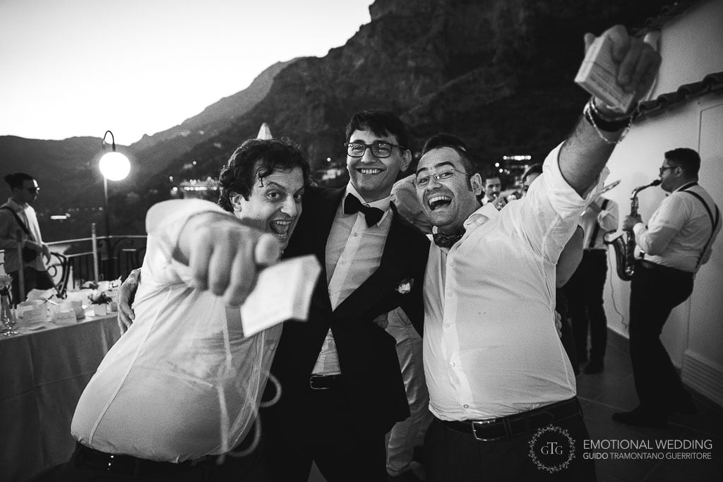 groom and friends at an open-air wedding reception in Praiano