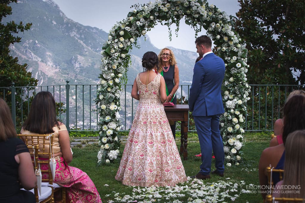 wedding couple and officiant during wedding ceremony at principessa di Piemonte gardens in ravello