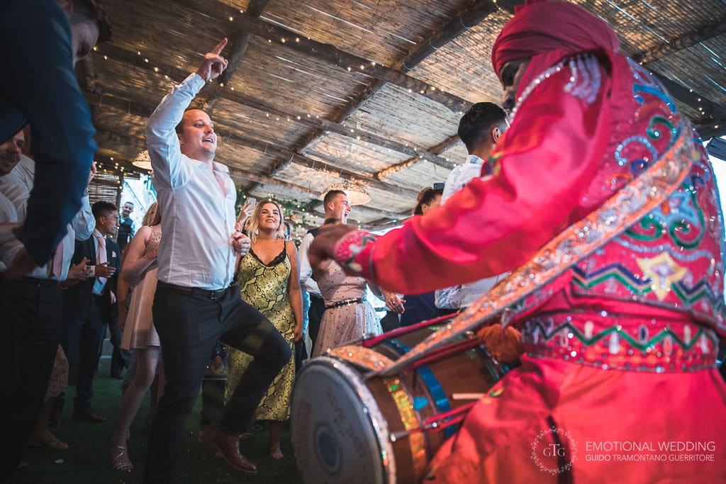 guests dancing at the beat of a DHOL at a wedding party in ravello