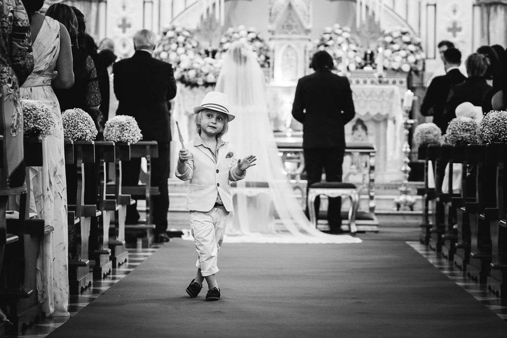 a little boy playing during a wedding ceremony