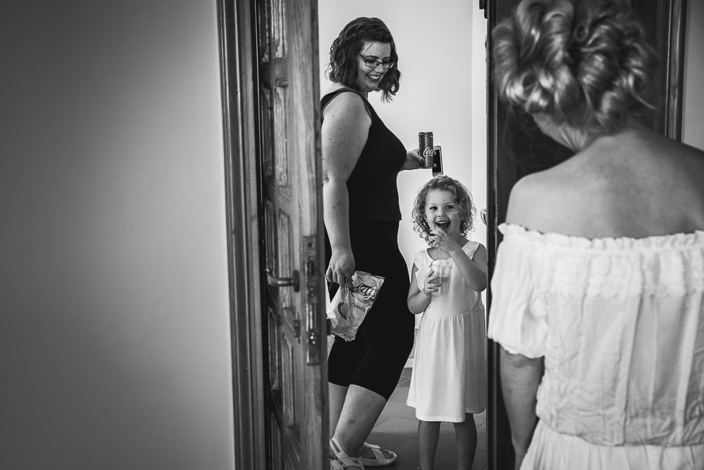 flower girls smiles as she meets the bride