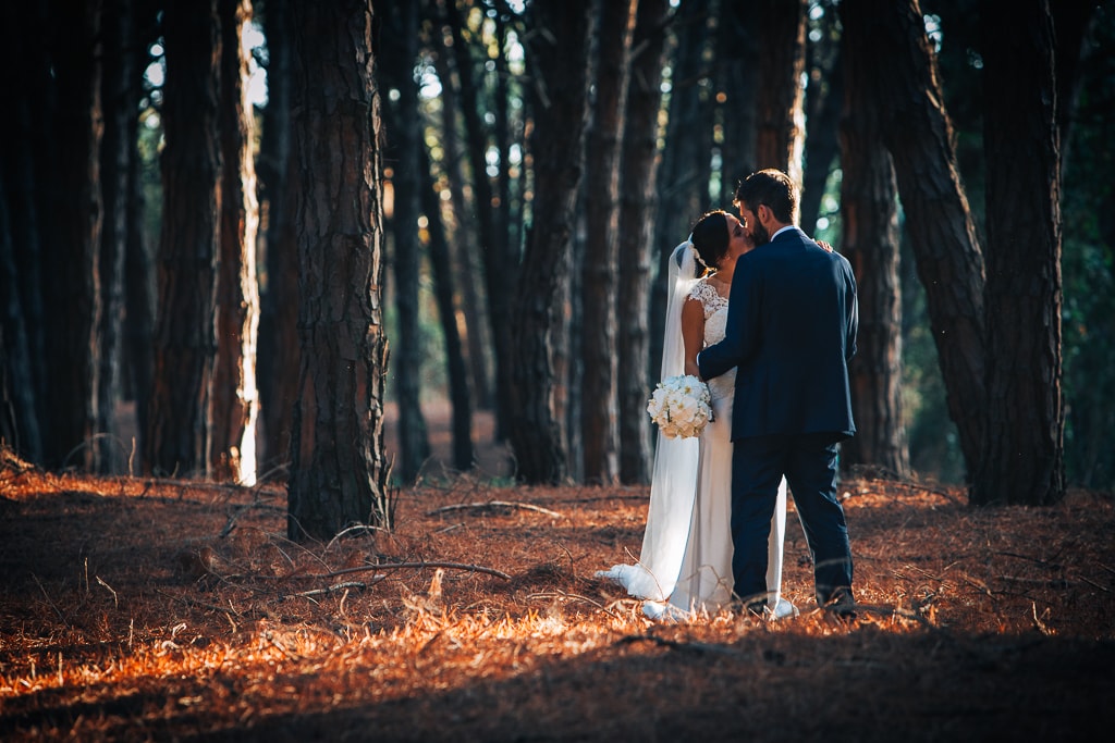 wedding couple kiss in a pine forest