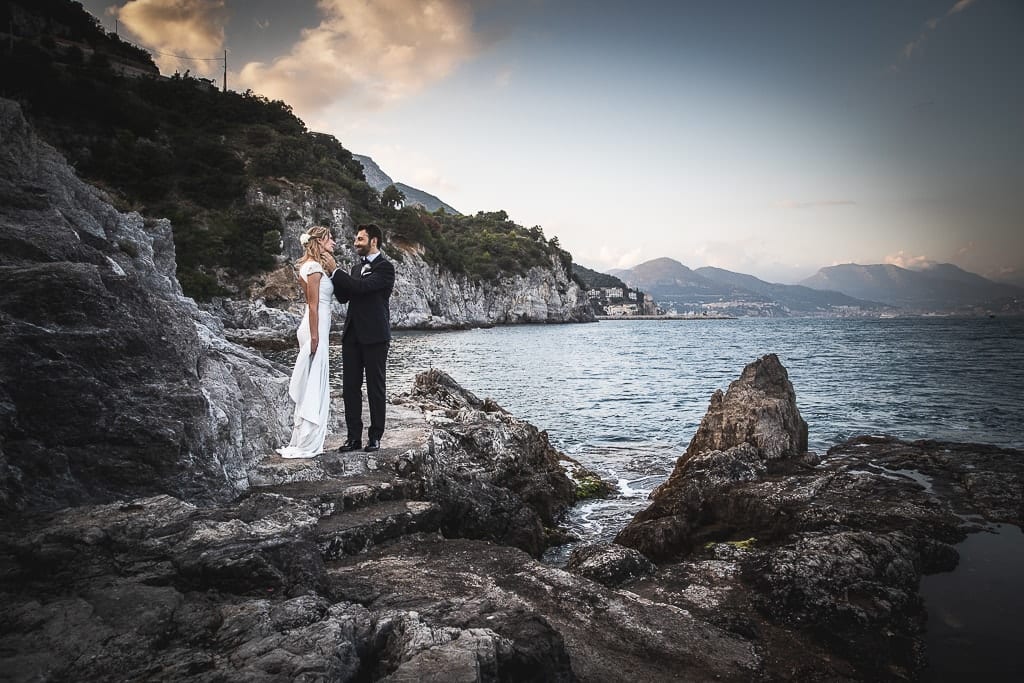 wedding couple on the rocks by the seaside in amalfi coast