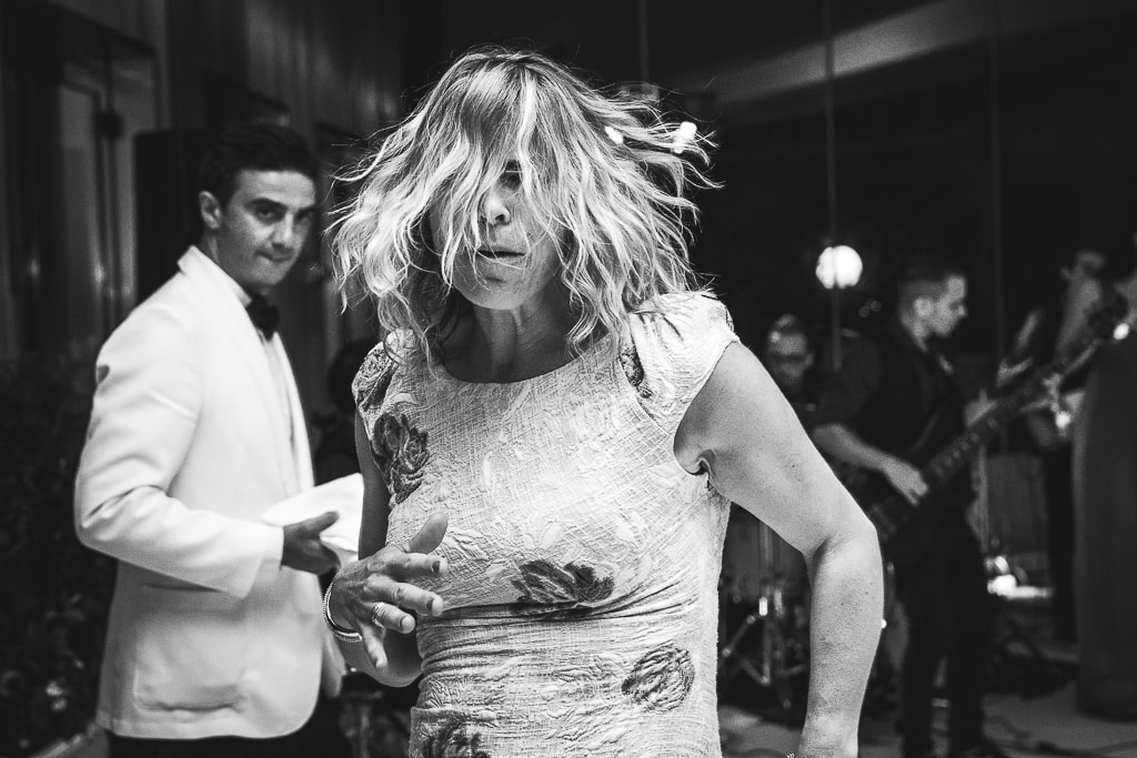 a funny portrait of a guest dancing at a wedding party