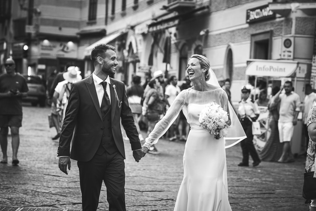 wedding couple walking and laughing in amalfi town