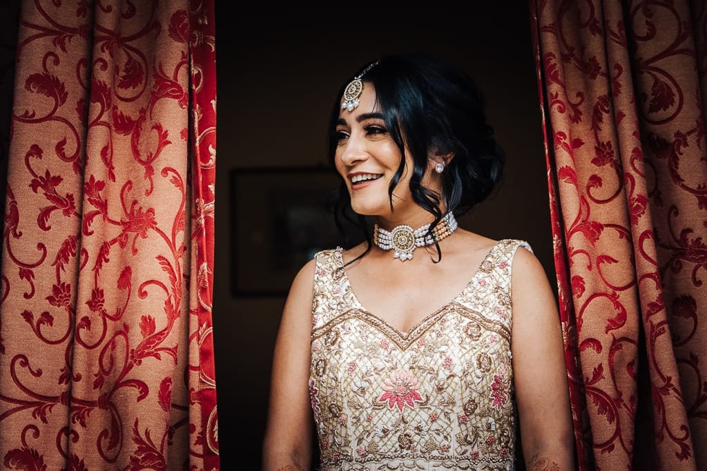 hindu bride at the window smiling