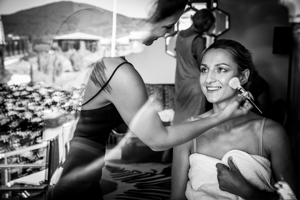 bride getting ready with her makeup artist