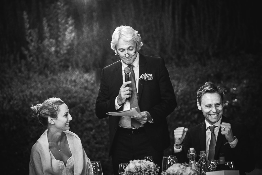 groom exults during a speech at a wedding in the tuscan countryside