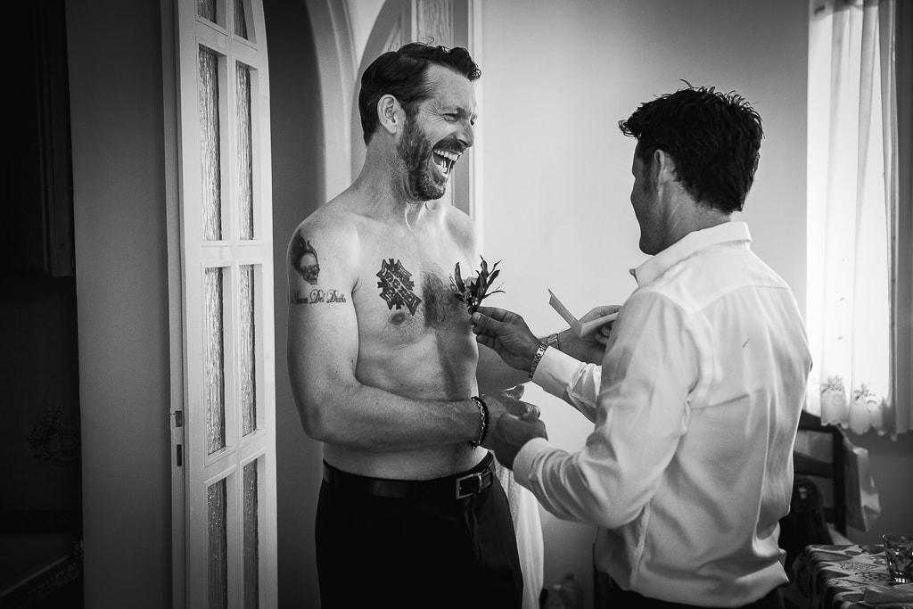 best man and groom joking while getting ready