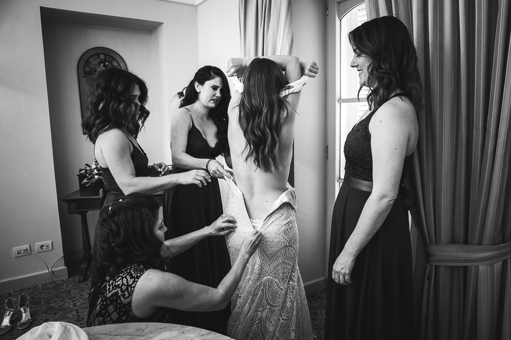 bridesmaids help the bride dressing