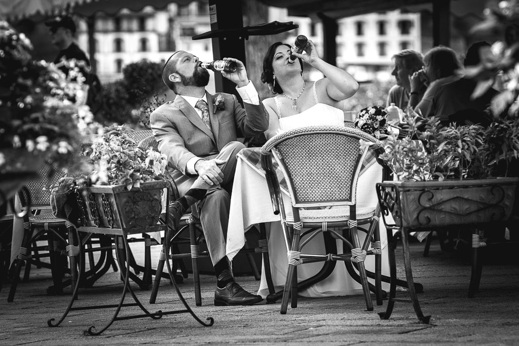 bride and groom drink beer while relaxing at a ravello pub in amalfi coast