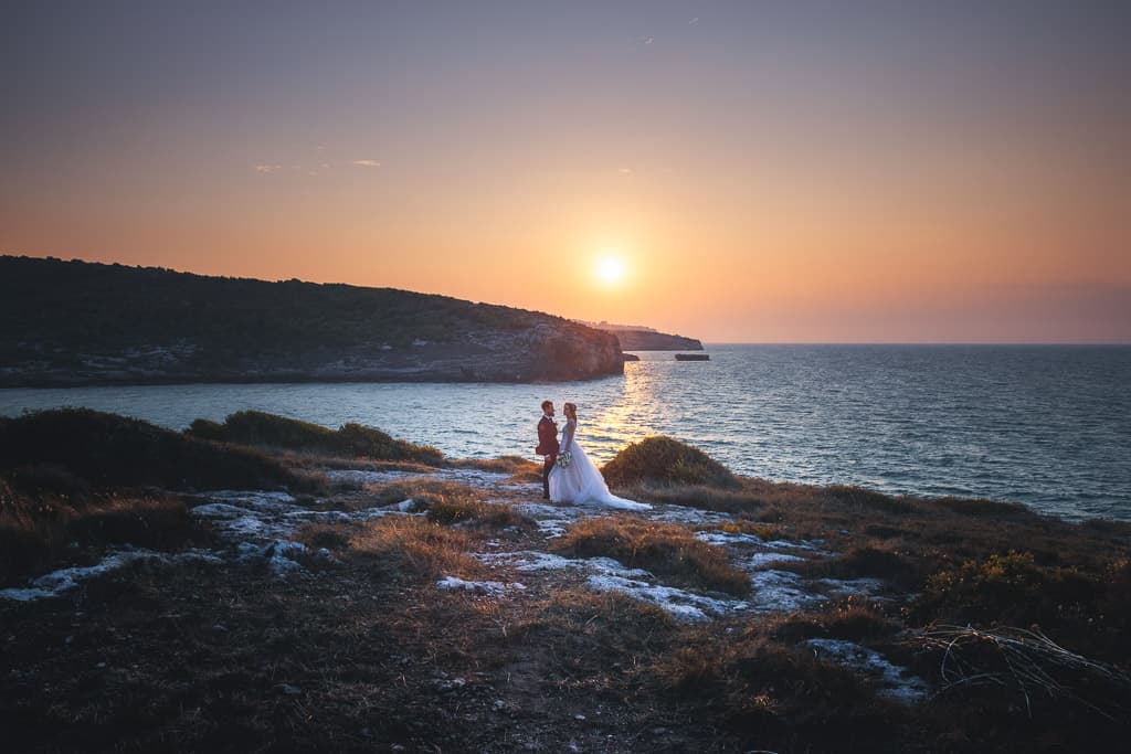 sunset on the apulia coast and a wedding couple