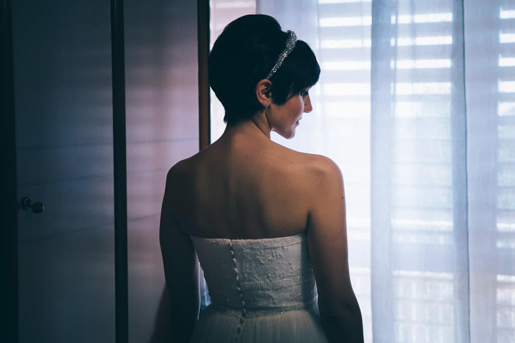 bride from behind looking outside the window