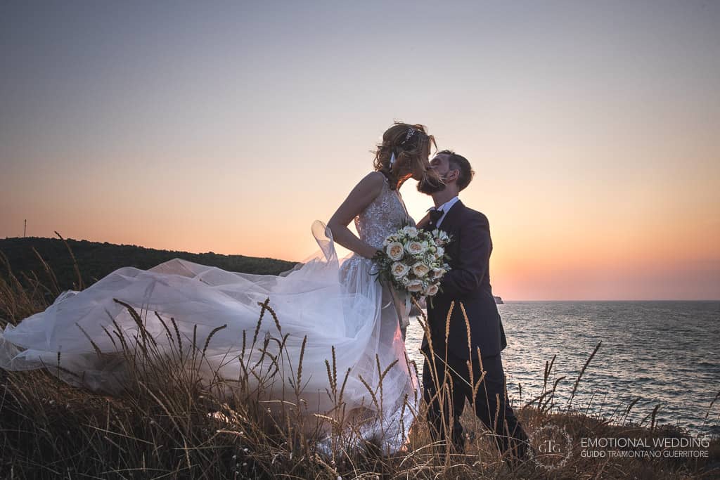 wedding couple romantic kiss at sunset in puglia