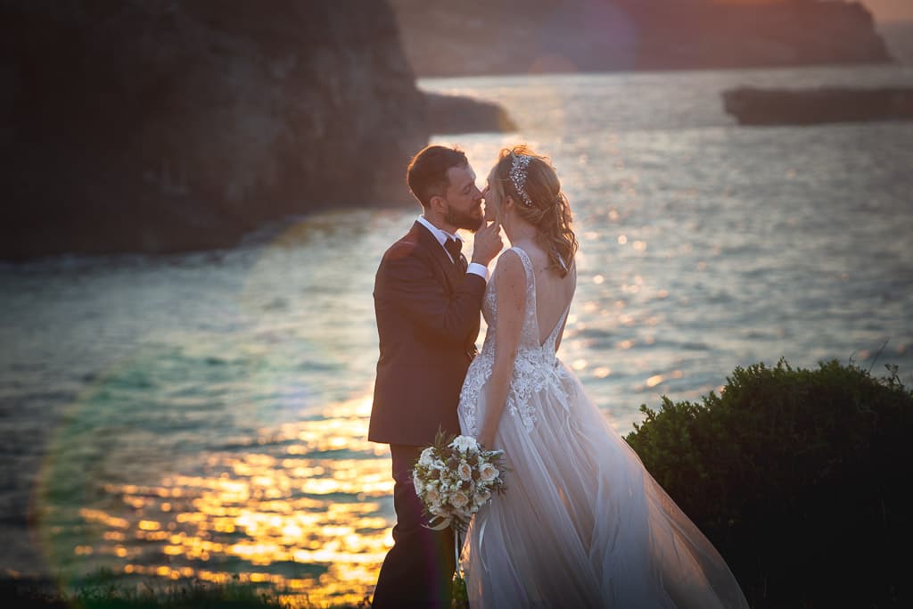 romantic moment at sunset of a wedding couple in apulia with a seascape in the background