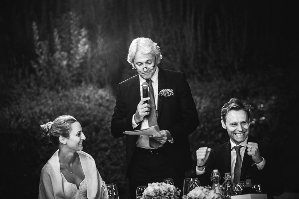 groom exults during a speech at a wedding in the tuscan countryside