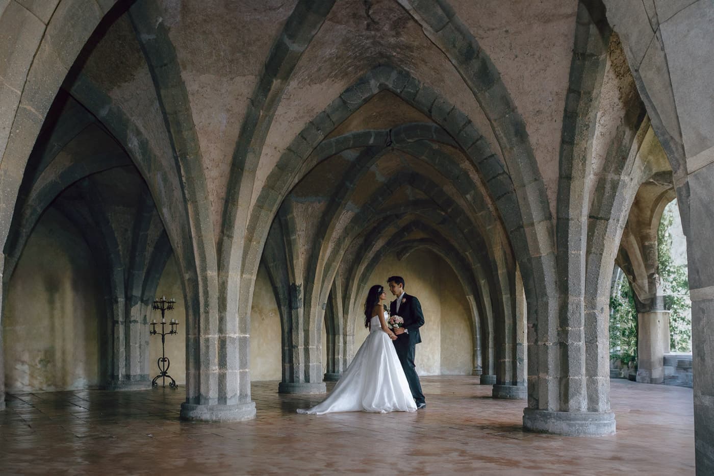 Dramatic wedding portrait of a couple in the historic crypt — Villa Cimbrone Ravello wedding photographer.