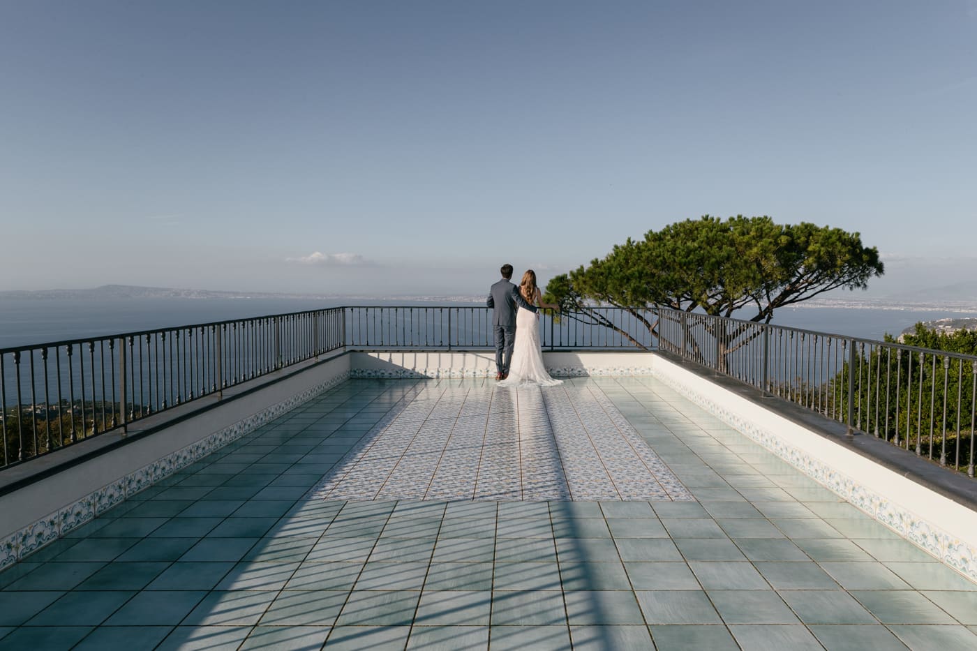 Elopement couple enjoying the view over the bay of Naples from a terrace in Sorrento