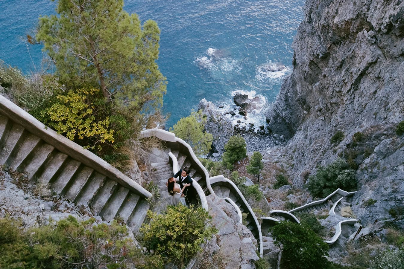 Intimate elopement couple on a dramatic cliffside staircase in Praiano, Amalfi Coast.